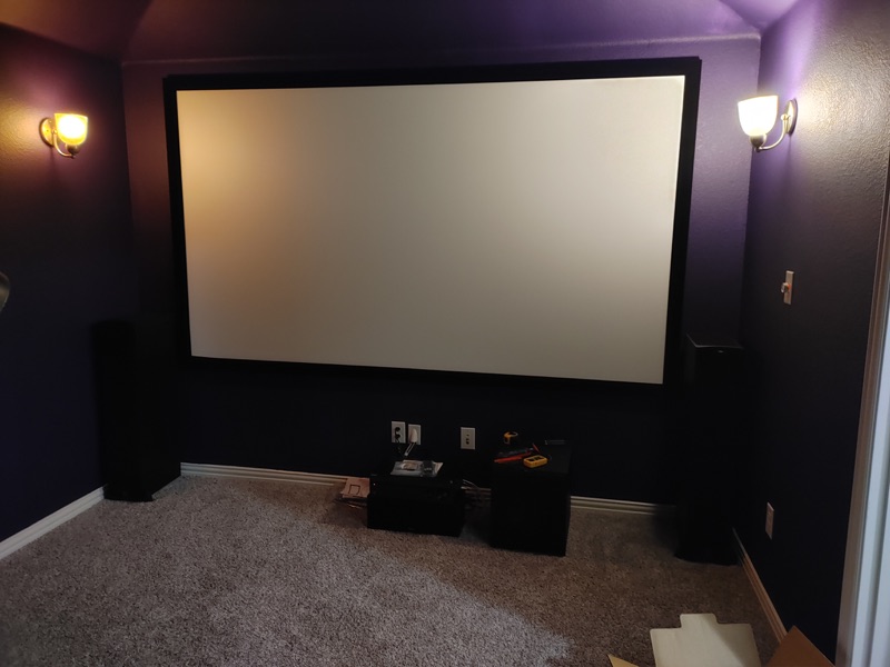 Real completed home theater with projector screen and speakers